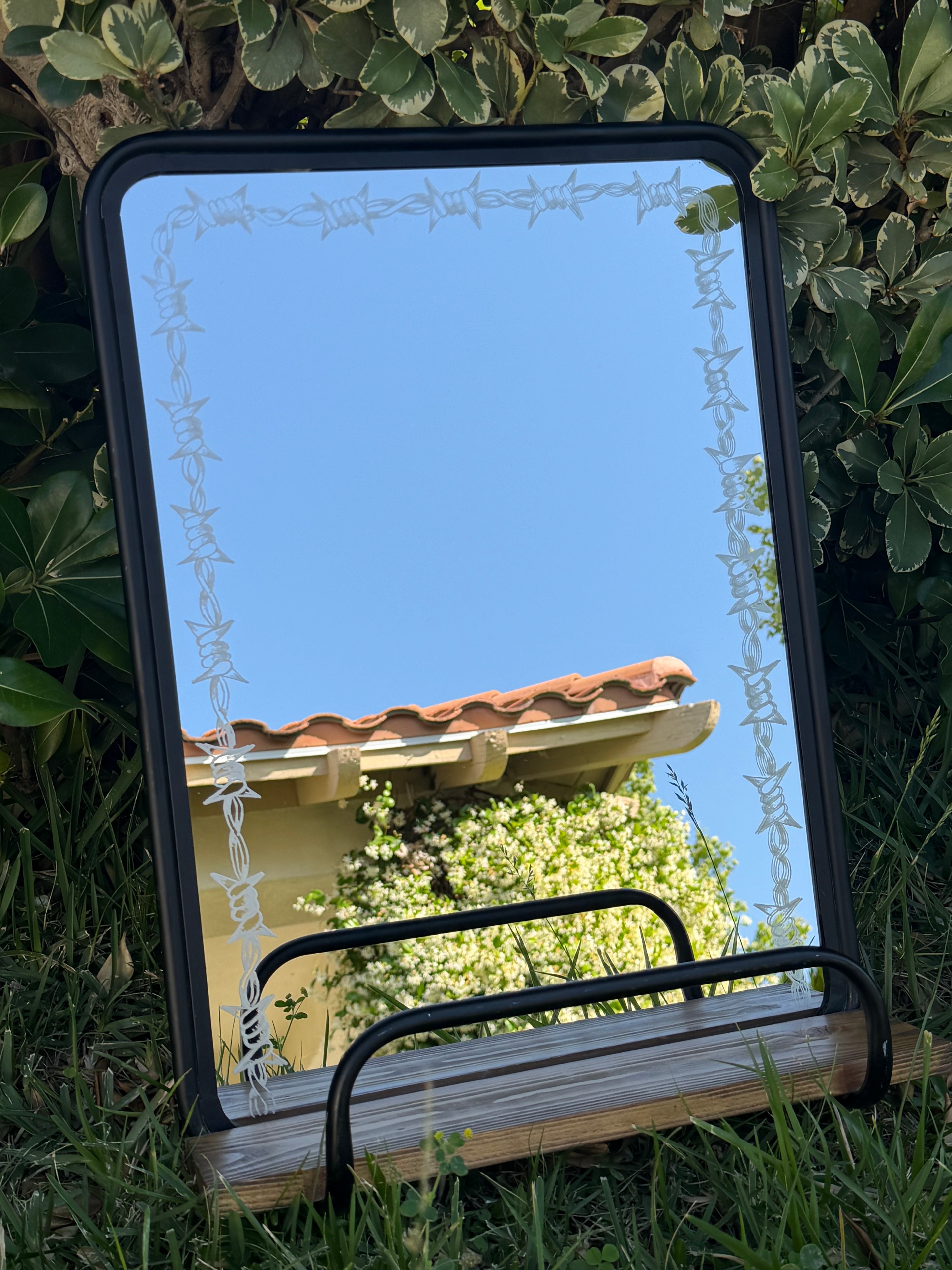Barbed wire shelf mirror